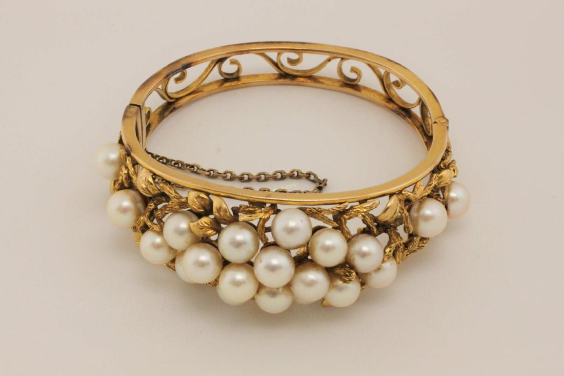 70s 14k Gold Bracelet w Pearls Naturalist Setting: Vintage1970s 14k Designer gold bracelet set with 7.5mm - 8mm pearls in a naturalist setting of leaves and vines. Excellent condition (minor wear). Measures 2.25" x 2.15" inside and 3.15" x 3" outside.