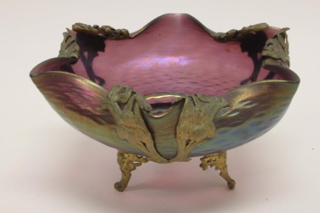 Loetz Art Nouveau Art Glass & Bronze Lily Bowl: Loetz Austrian Art Nouveau art glass and bronze bowl. Metal mounts in the form of lily flowers form a footed base for a Loetz glass low bowl. Excellent condition. Measures 7" dia x 3.75".
