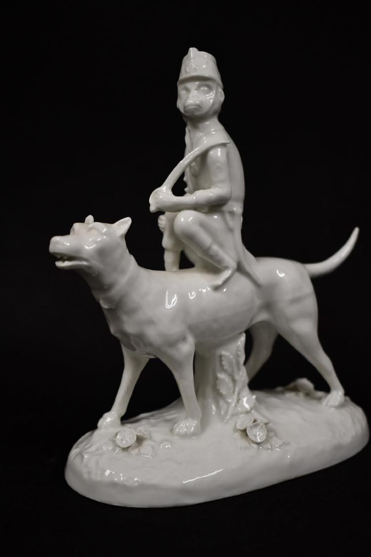 Paris Porcelain Monkey w Sword Riding a Large Dog: Paris Porcelain monkey with sword riding a large dog. Marked on base and en verso with crossed arrows. Excellent condition. Measures 6" x 3" x 7".
