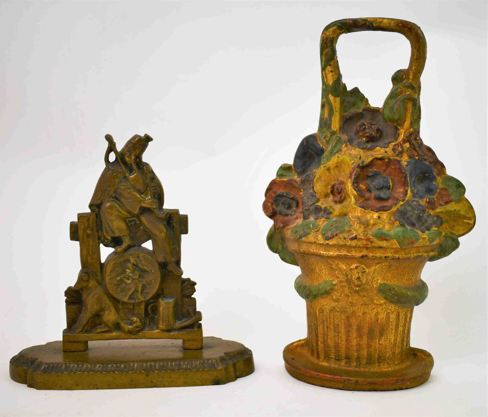 2-Victorian Door Stops Flower Basket & Piper w Dog: (2) Victorian door stops. (1) Heavy cast iron painted flower basket. Excellent condition. Measures 7" x 2" x 11.5" (1) English half piper with his dog seated on a fence with a mug of ale. Excellent co