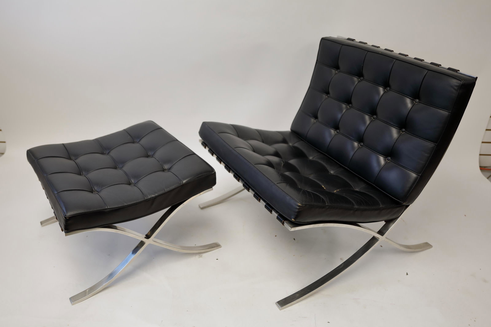 Knoll International Van der Rohe Chair & Ottoman: Ludwig Mies van der Rohe design Barcelona chair and matching leather ottoman with polished stainless steel frames. Made by Knoll International. Upholstery tags still attached to the chair and stool. E