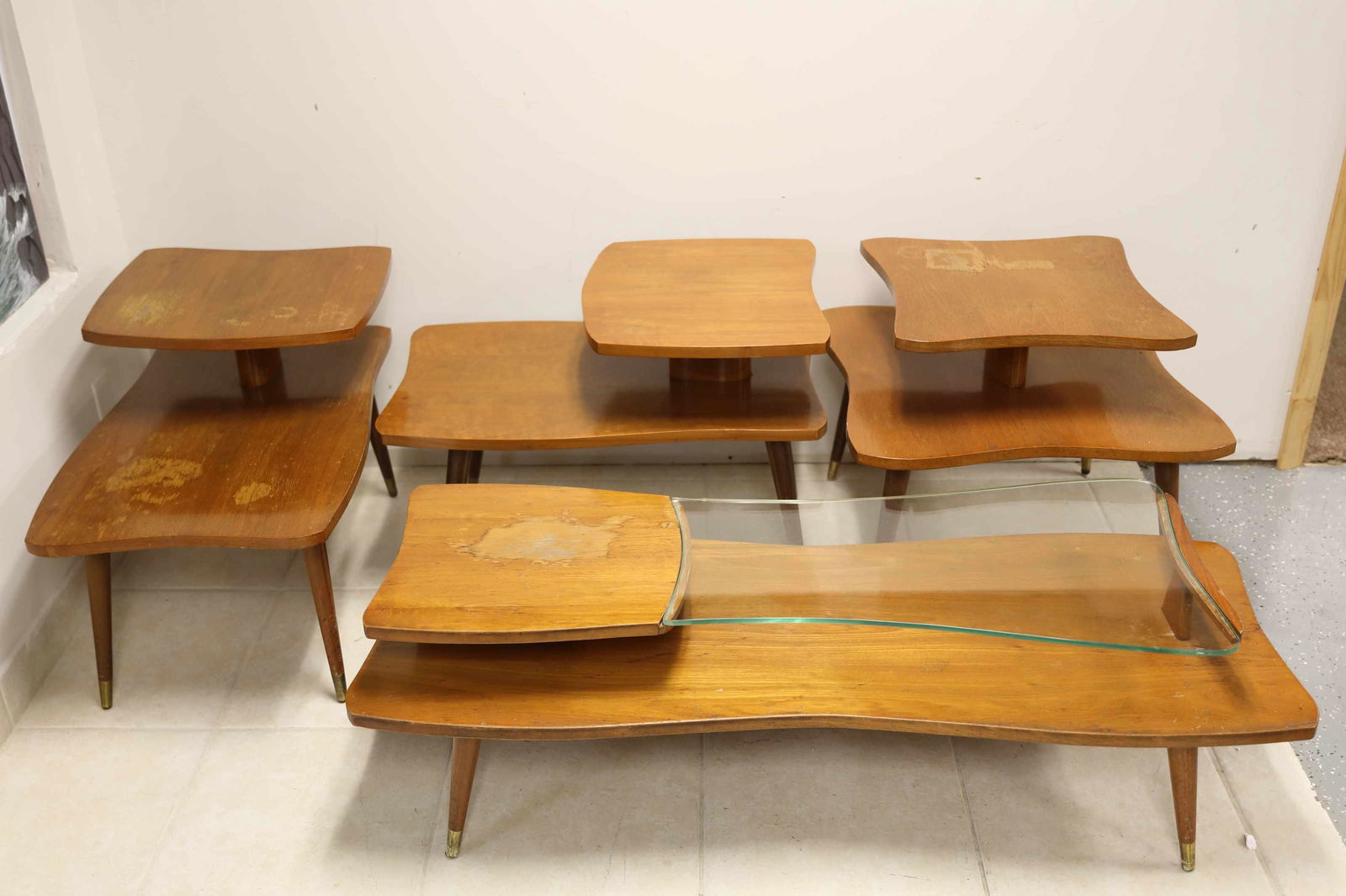 (4)pc 50's Teak Atomic Retro Living Room Set: 4 piece Vintage 1950's sculptural living room table set solid wood construction with brass wrapped feet and unique two tier design. Set includes: (2) - Side tables. 20" x 32" x 22.5" (1) - Square side