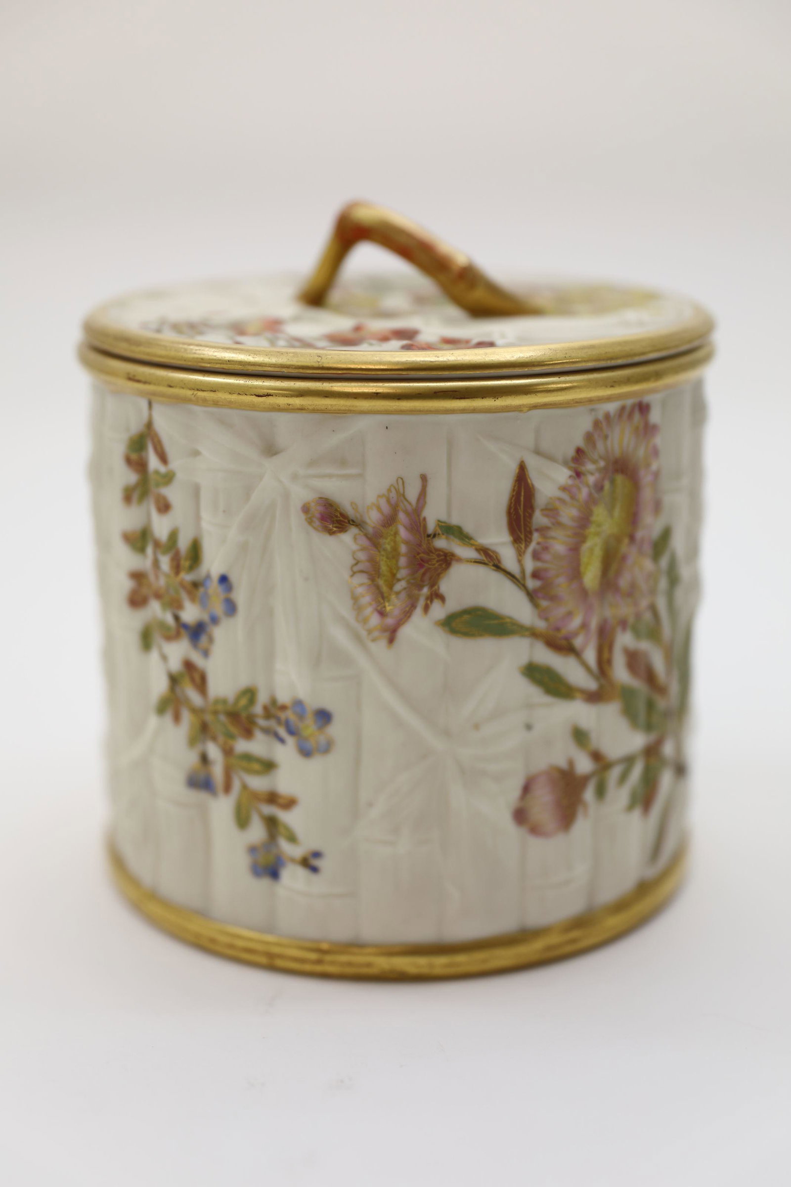 19c Royal Worcester Bamboo Floral Biscuit Jar: 19th Century Royal Worcester biscuit jar. Bamboo relief porcelain jar with a bamboo handled lid, hand painted with accented flowers. Excellent condition. Measures 6" dia x 6.5".