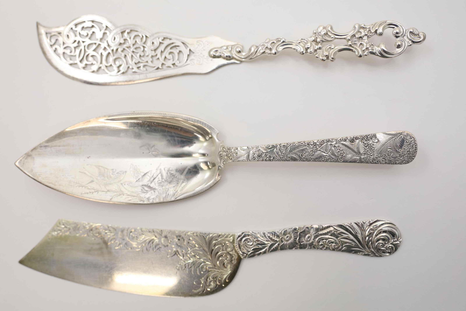 3-19c Sterling Fish Server Fish Knife & Ice Cream: (3) 19th Century sterling silver serving utensils. (1) 12" Repousse fish server by JE Caldwell Co. (1) 12.5" Silvercraft Rococo fish knife (1) 12.5" Cowell & Hubbard Victorian Ice Cream knife. Total w