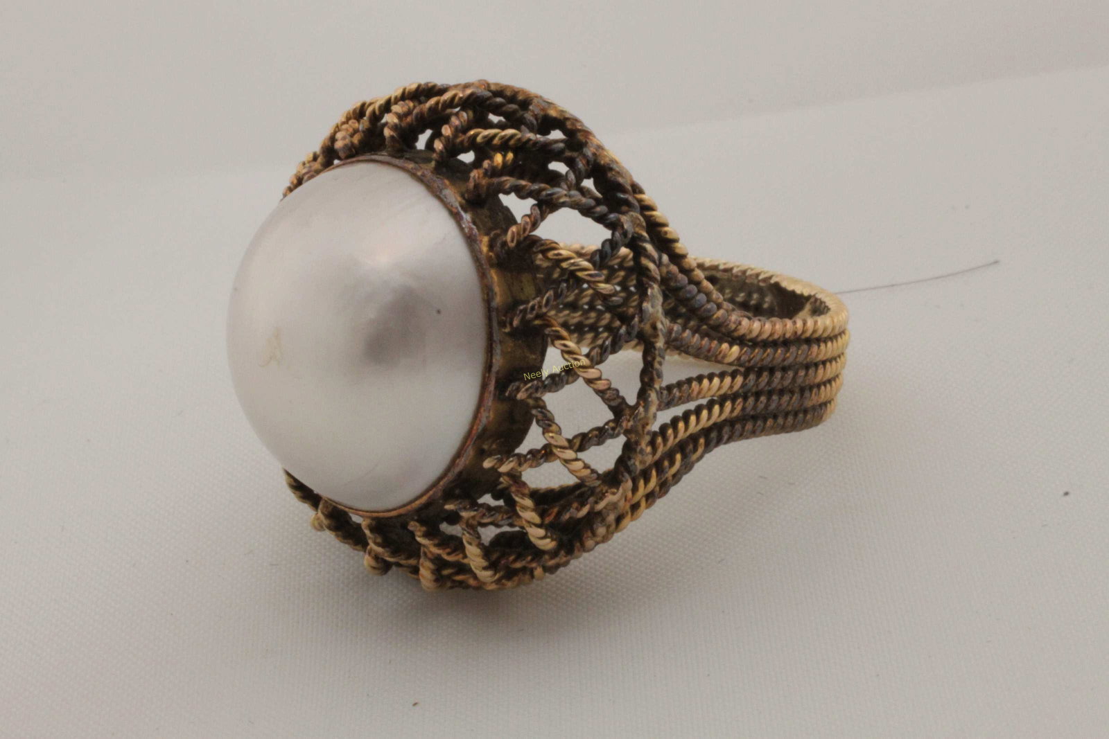 14k Gold Mabe Pearl Sheffield Inc Rope Twist Ring: 14k Gold rope twist and Mabe pearl cocktail ring by Sheffiend, Inc. Pearl measures 18 mm. Total weight = 11.5 g or .37 troy oz. ***All silver, gold and jewelry purchases must be verified to prevent fr