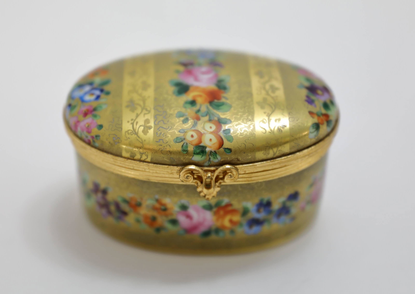 Cartier Porcelain Lidded Box w Gold & Flowers: French porcelain for Cartier lidded Box with gold finish and hand painted floral details. Excellent condition. Measures 3.75" x 2.5" x 2.25".