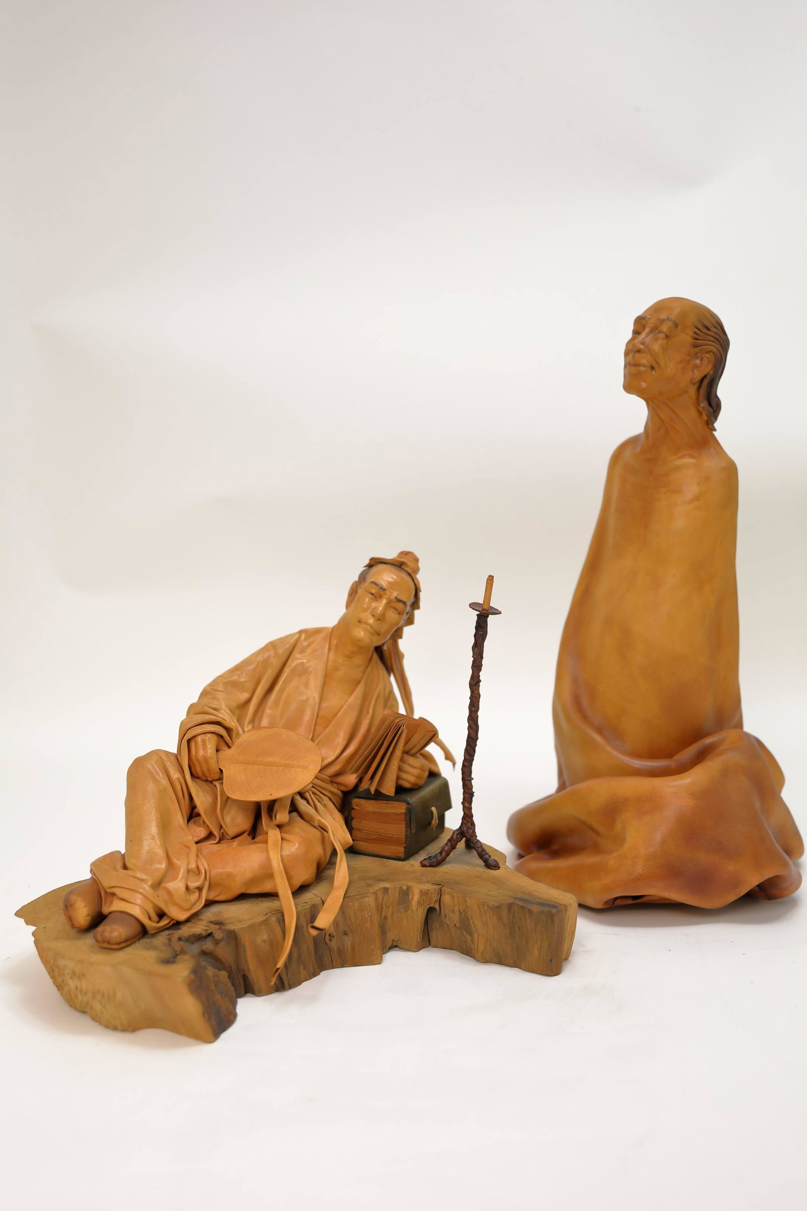 2) Liu Miao Chan (Taiwan, 1946) Figural Sculptures: (2) Liu Miao Chan (Taiwan b1946) Figural leather sculptures. Reclining figure of an oriental (1) Confucian scholar mounted on a wooden plinth. Excellent condition. Measures 15" x 11" x11". (1) Figure 