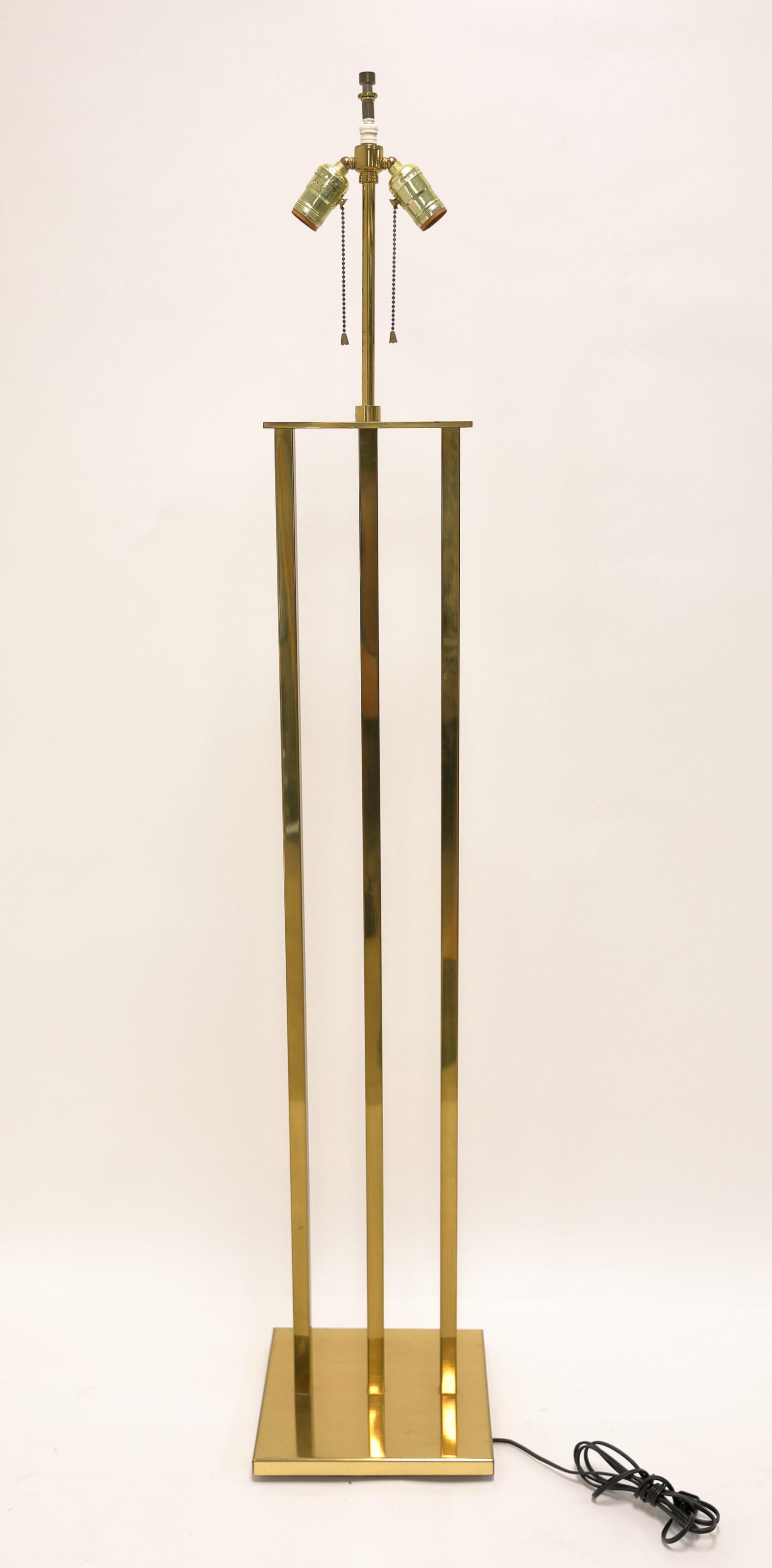 Frank Lloyd Wright style Polished Brass Floor Lamp: Frank Lloyd Wright style polished brass floor lamp with three vertical columns on rectangular ends. Excellent condition. measures 10" x 10" x 53" to switch.