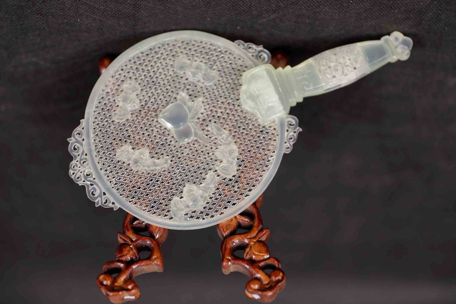 Chinese White Jade Fan w Bats & Persimmons: Chinese carved white jade fan decorated with bats and persimmons. Reticulated fan and handle are finely crafted with scrolled detail. Includes a wood stand. Excellent condition. Fan measures 4.25" x 7