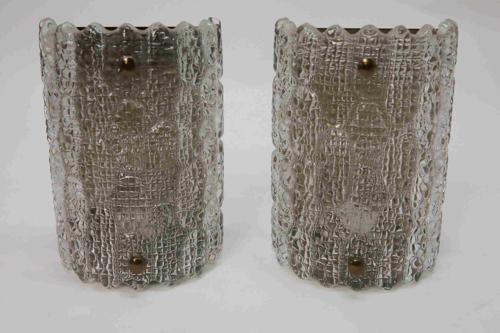 2 Orrefors Cylinder Form Impressed Crystal Sconces: Pair of Orrefors cylinder form impressed crystal sconces mounted on bronze frames. Excellent condition. Measures 7" x 4.5" x 10"