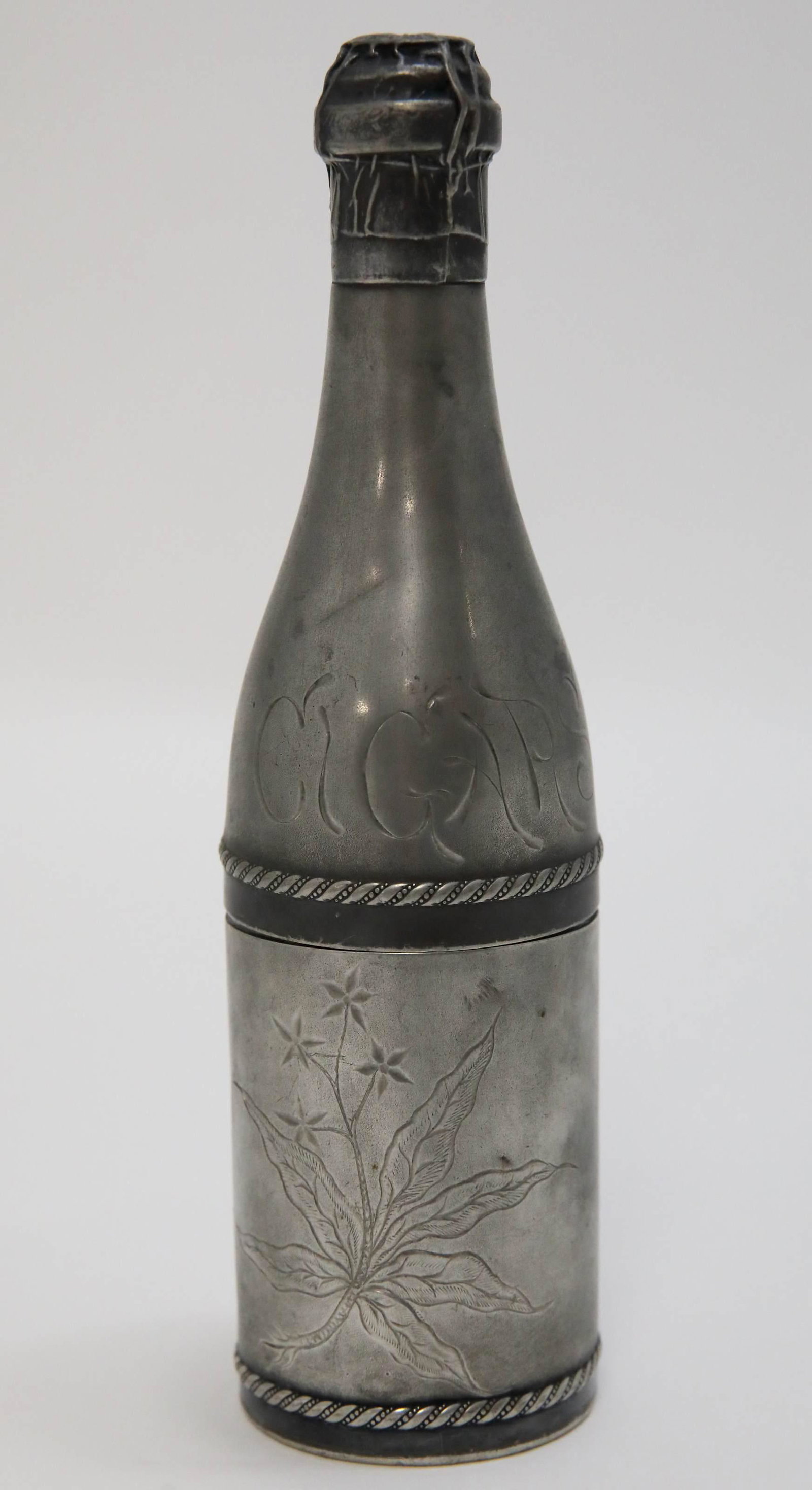 Pairpoint Silver Plate Champagne Bottle Cigar Box: Pairpoint silver plate cigar holder in the form of a champagne bottle. Very good condition, some wear & dings. Measures 3.75" dia x 10".