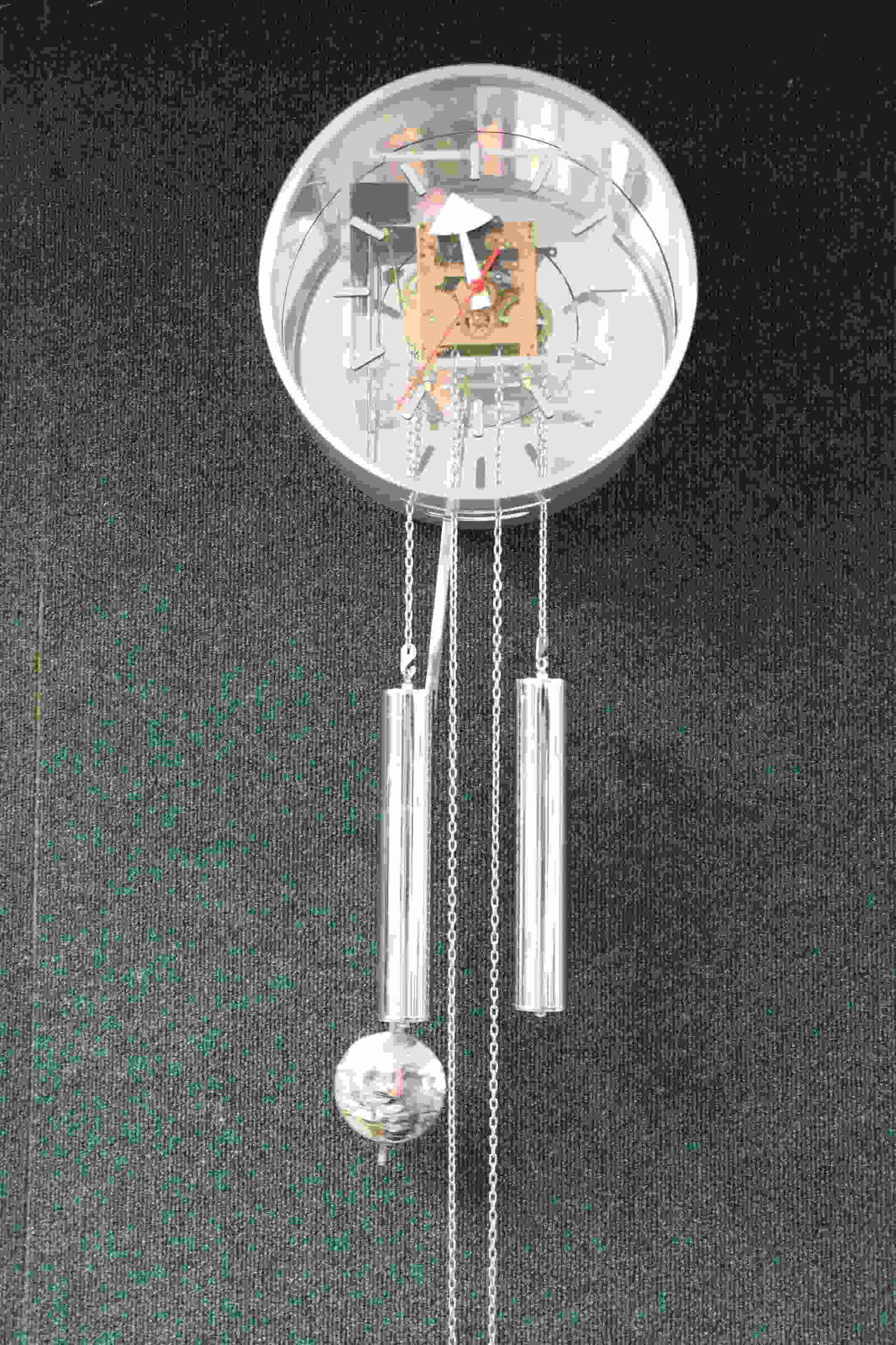 George Nelson (1908-1986) Howard Miller Wall Clock: George Nelson (1908-1986) for Howard Miller Metal and Lucite Wall Clock, c. 1960. Brushed aluminum case, Lucite face, mirror back, pendulum and chrome weights. Measures 12 " x 6.5" x 28".