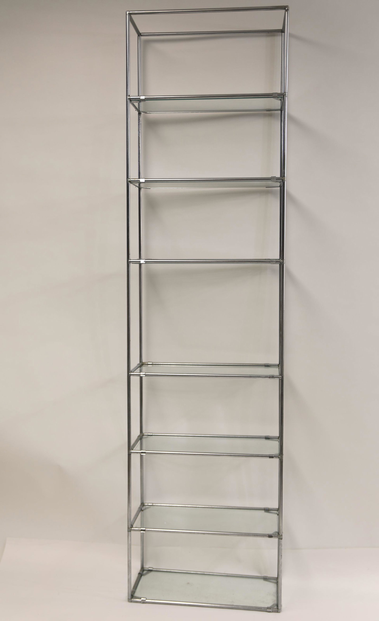 MCM 7 Tier Italian Chrome Rod Display Shelf: Mid Century Modern 7 tier Italian chrome rod modular display shelf. Suspended glass shelves disassemble with interlocking hubs. Very good condition, needs polished. Measures 21" x 11.5" x 81".