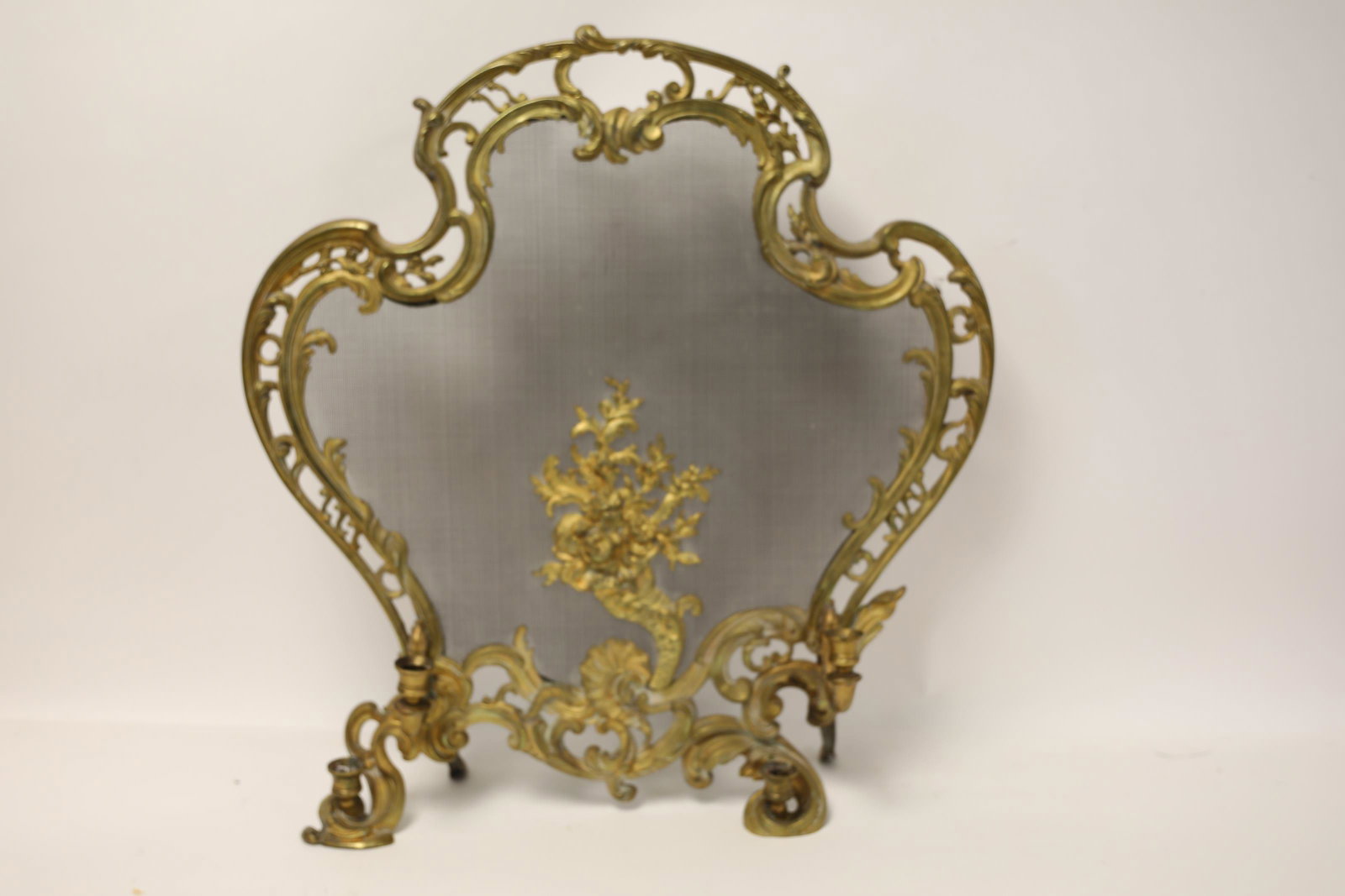 Roccoco Style Fire Screen w Bouquet Bas Relief: 19th Century Roccoco style fire screen with bouquet bas relief and candle holder feet. Excellent/good condition (minor trim to left foot, back legs not secure. Measures 27.5" x 30".