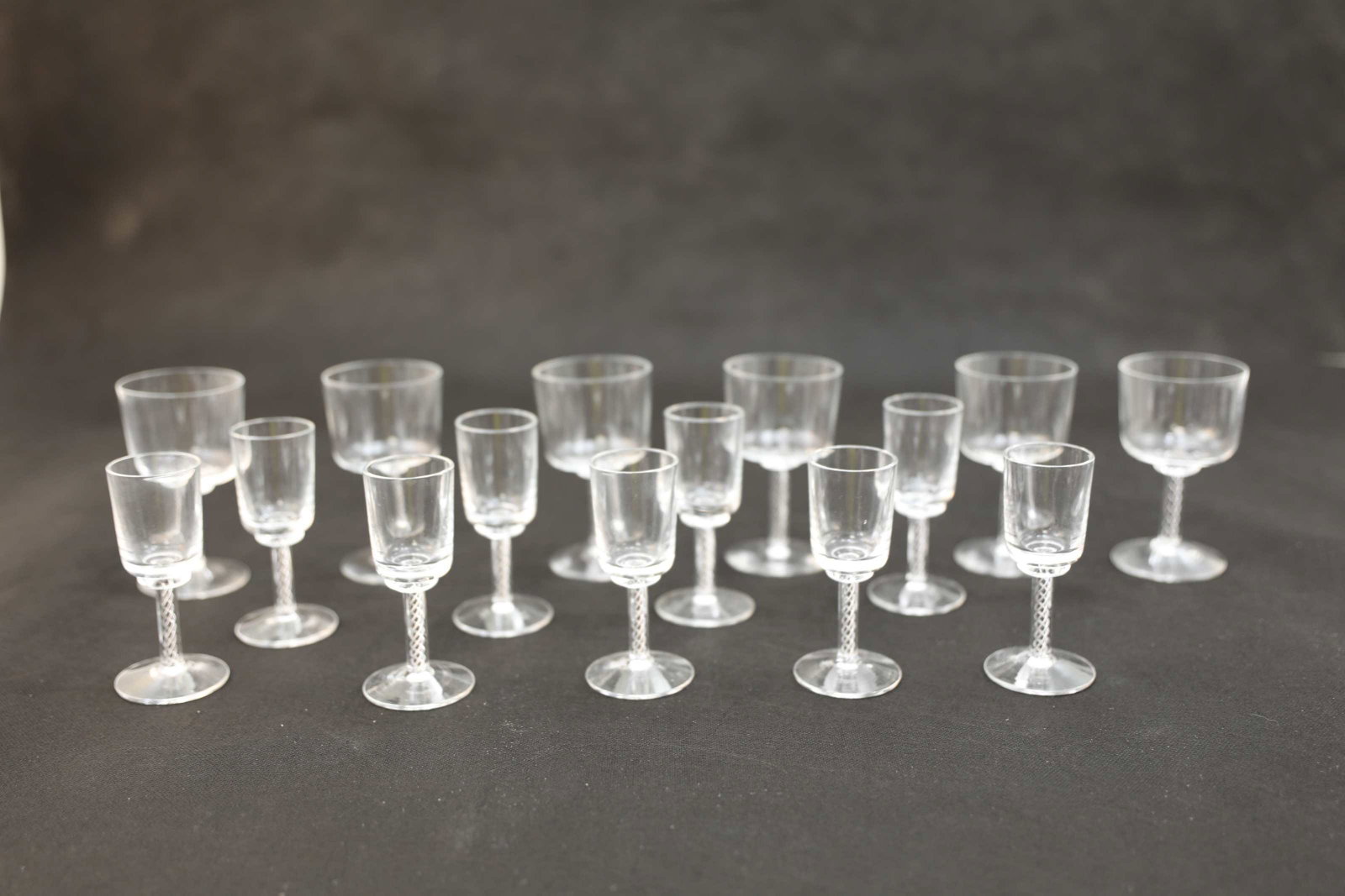(15) Vintage Kosta Boda Crystal Glasses: (15) Vintage Kosta Boda crystal drinking glasses with air twist stems, including (6) brandy glasses measuring 4.5" x 2.5" dia. and (9) sherry glasses measuring 4.5" x 1.5" dia. Excellent condition.