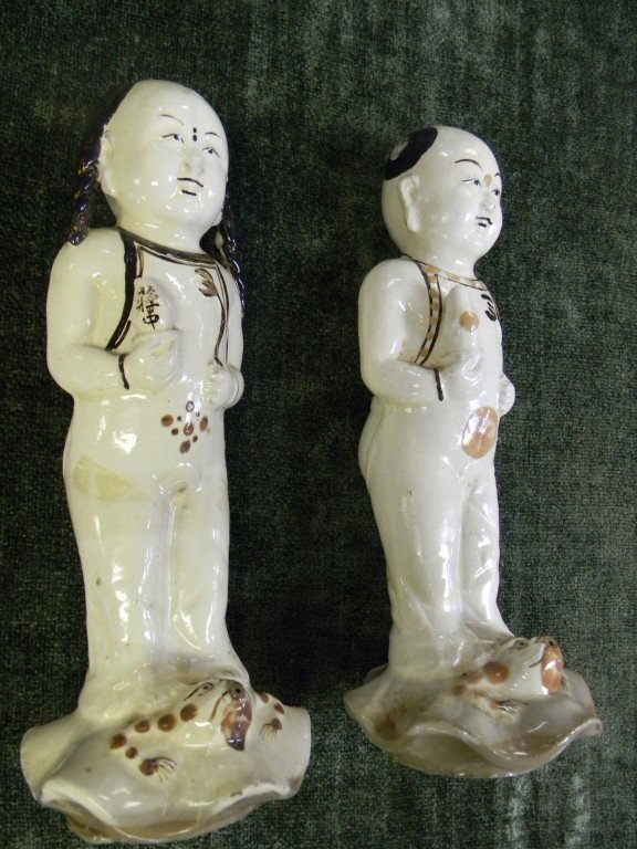 Pair of Chinese earthenware figures.: 2 Chinese earthenware figures with lotus form bases. 11" x 4" diameter.