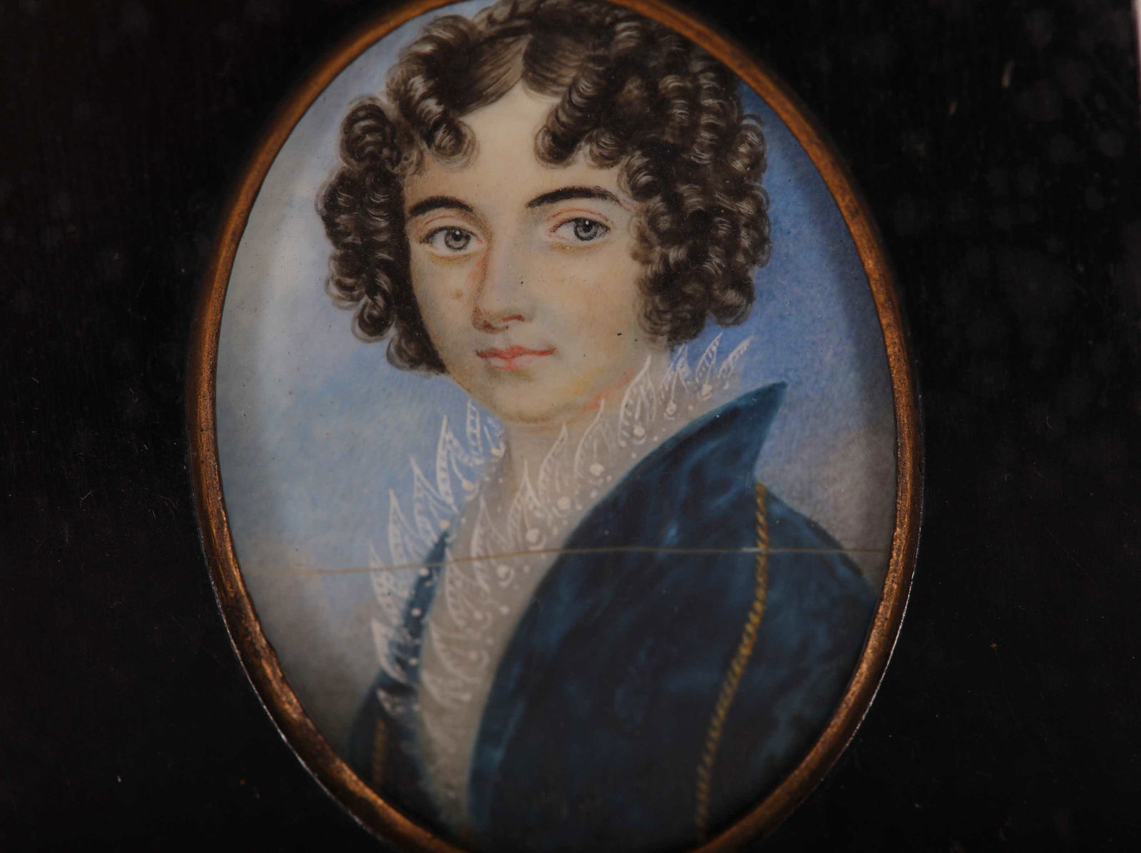 19th C. Ebony Frame Miniature Portrait Painting: 19th Century ebony square framed miniature portrait painting on bone of figure wearing a coat with a laced collar. Frame features dore bronze acorn above painting and obscured writing beneath tape on