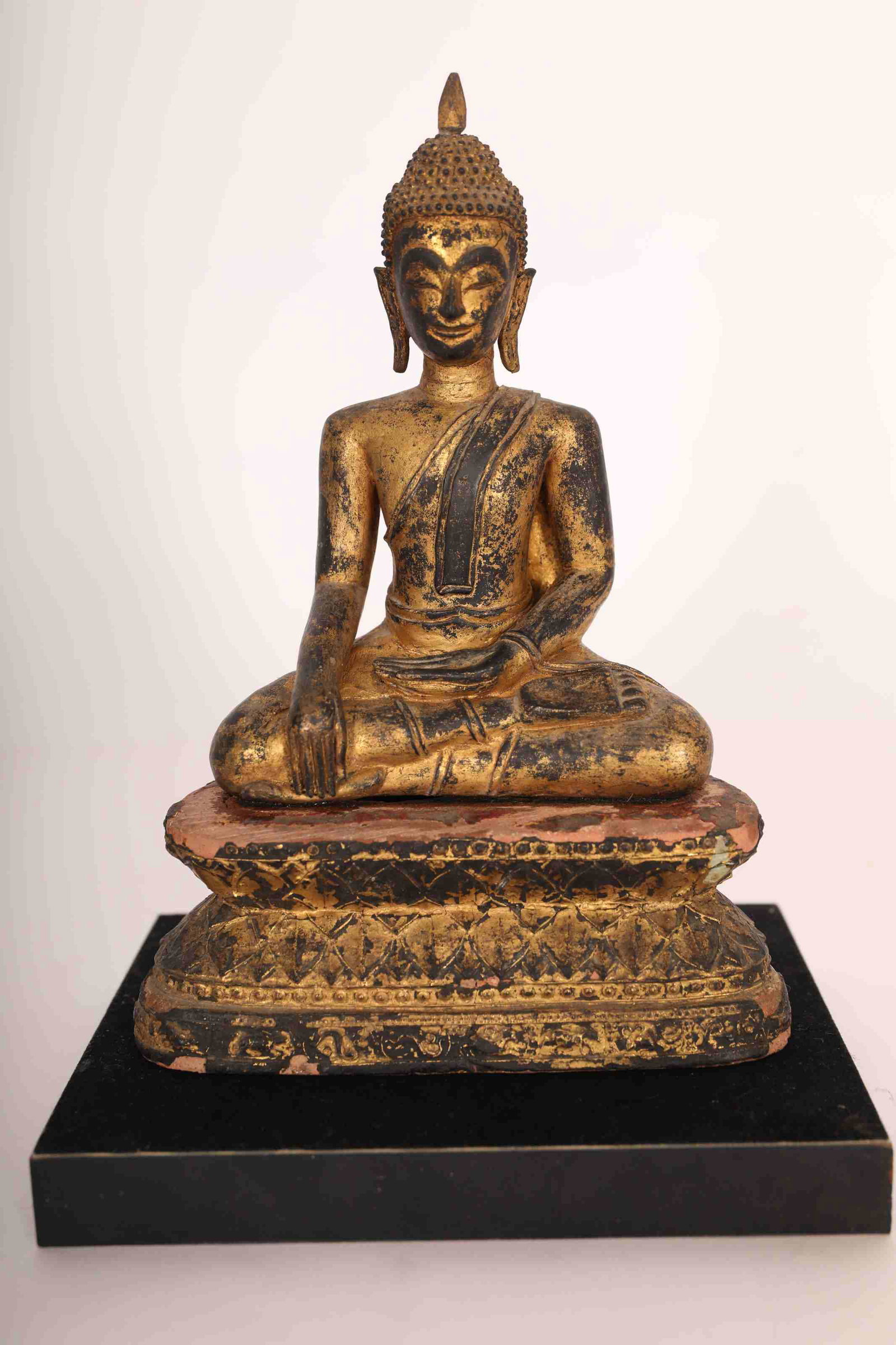 19th C. Ayuthya Buddha Gilt Carved Wood Terracotta: 19th century Ayuthya Buddha gilt carved wood sculpture on terracotta base. Seated in Bhumisparsha mudra and lacquered in black beneath gold leaf. Excellent condition ( loss to lacquer on base and appr