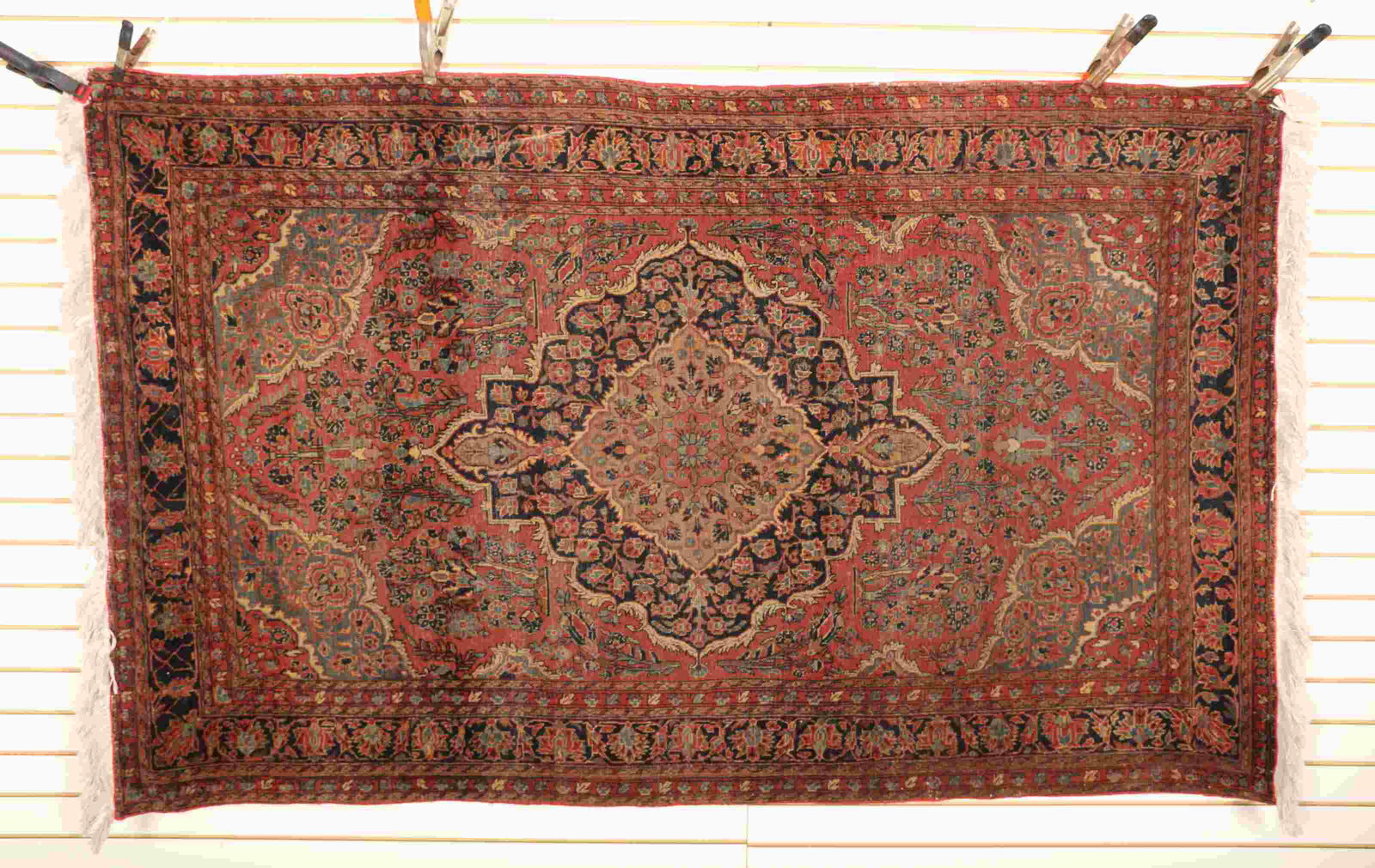 Antique Persian Overall Red Tightly Bound Wool Rug: Antique Persian overall red tightly bound wool rug with floral center medallion and tassels. Excellent condition. Measures 41.5" x 57".