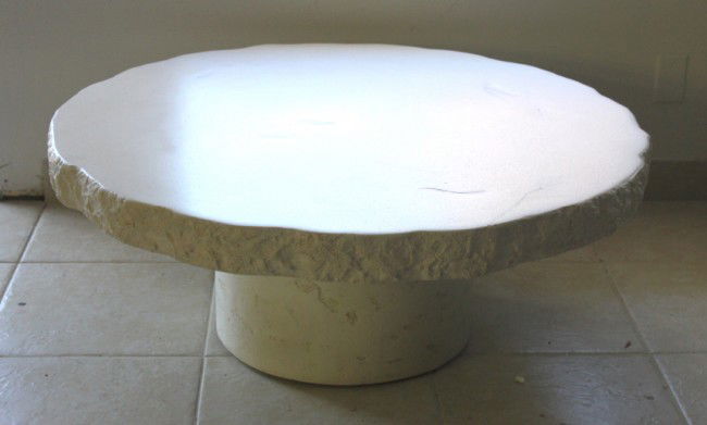 White Circular Coffee Table: White circular coffee table in the manner of John Dickinson. Set on a strongly built plywood sub-straight. 19"d cylindrical base. Dimensions: 42"d x 16.5"t Style/Time Period: Modern