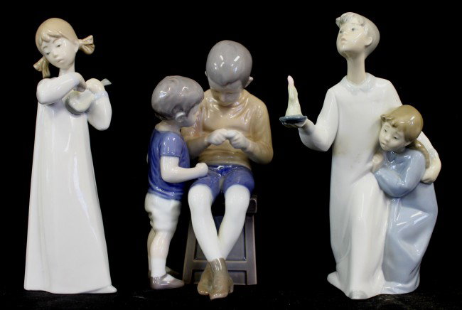 Lot of (3) Lladro and Royal Copenhagen Figures: Set of (3) porcelain figurines. (2) LLadro figures: girl with violin (measures 8.25"t) and 2 boys wi candle (measures 8.25"t). (1) Royal Copenhagen of 2 boys at a bench (measures 7.75"t) Dimensions: S