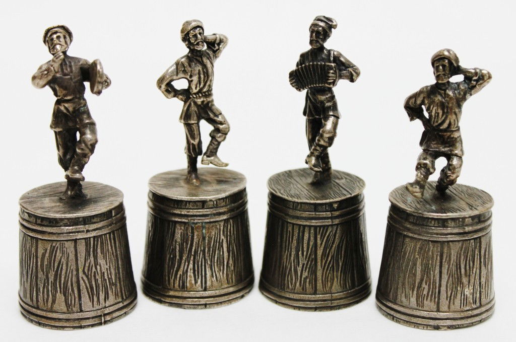 4-Pc. Russian Sterling Silver Shot-Cup Set.: 4-piece Russian sterling silver shot cup set decorated w/ musicians and dancing figurines. Marked, and stamped "AK 1867 84". Total weight = 8.25 oz. Dimensions: 1 1/4"d x 2 7/8" Style/Time Period: 1