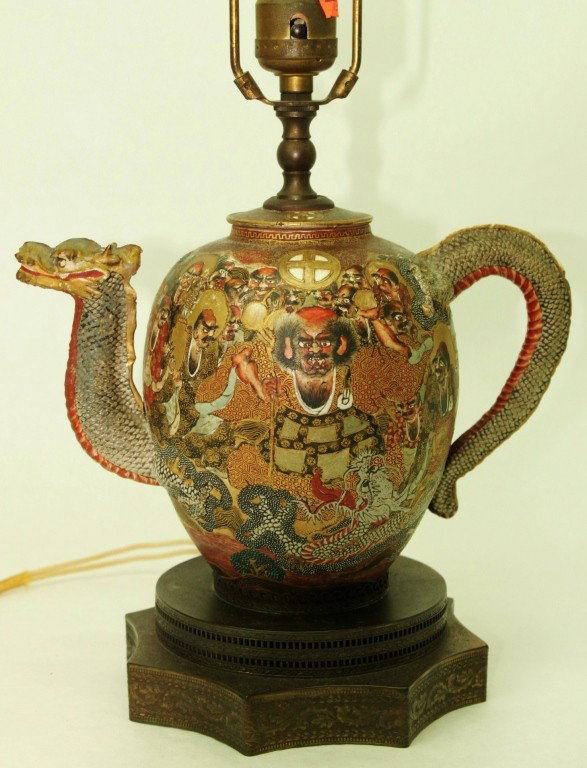 19th c. Japanese Satsuma Tea Pot Lamp, 1000 Faces: Japanese Satsuma tea pot, mounted as a lamp. Decorated in the manner of 1000 faces. Restoration to spout and dragon head. Dimensions: 5" x 7" x 10" Style/Time Period: 19th Century