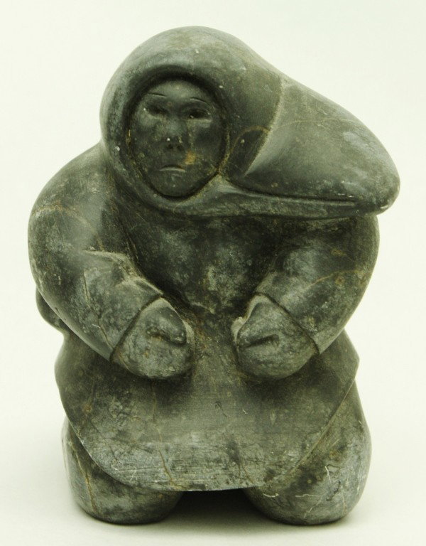 Inuit Carving of a Eskimo: Finely carved Inuit soapstone carving of an Eskimo. Pre-modern. Dimensions: 5 1/2" x 7 1/2" x 5 1/2" Style/Time Period: Pre-modern