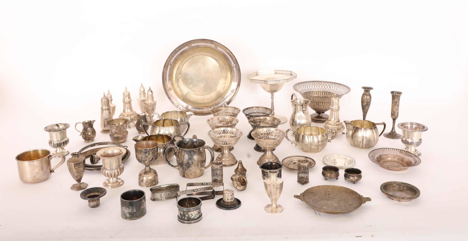 (60) Pc Lot of Sterling Table Accessories: (60) Piece lot of sterling table accessories: (10) sugar and creamers, (2) childrenâ€™s cups total 26.5 troy oz., (5) napkin rings total 4.4 troy oz., (4) cigarette urns total 6.7 troy oz., (8) s