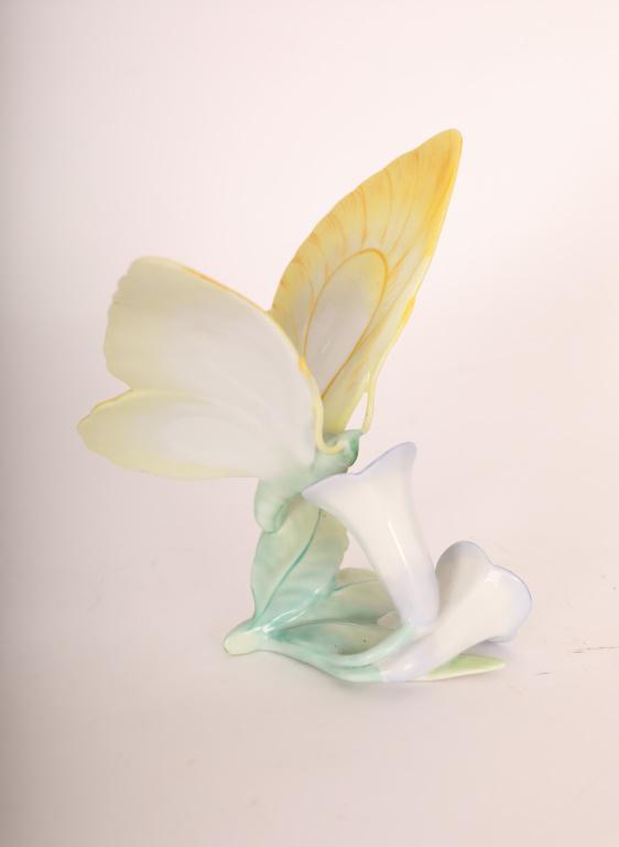 Porcelain Herend Hungary Butterfly On Flower Fig.: Porcelain Herend Hungary butterfly on trumpet flower figurine. Marked on base. Excellent condition. Measures 6" x 5" x 5.5".