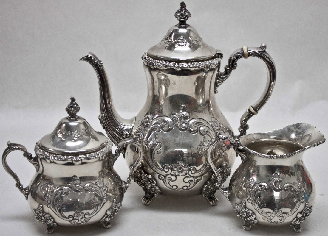 Poole 'Old English' Sterling Silver 3 pc. Tea Set: Pool 'Old English' pattern sterling silver 3 piece tea set with teapot, sugar and creamer. No monogram, hand chased. Sugar is 6" x 6" x 4", 17.05 oz. Creamer is 5.5" x 4.5" x 4", 13.85 oz. Tea pot is 