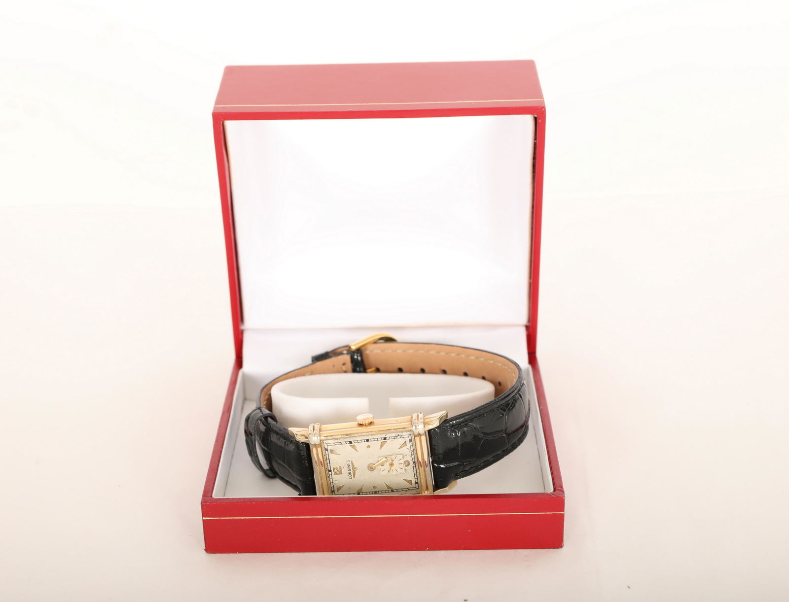 14Kt White & Yellow Gold Longines Tank Watch: 14Kt White & Yellow gold filled Longines Tank Watch. Band marked "17 Genuine Leather" and "I. W. Suisse". Comes in box. Excellent working condition. Some wear to corners of watch face.