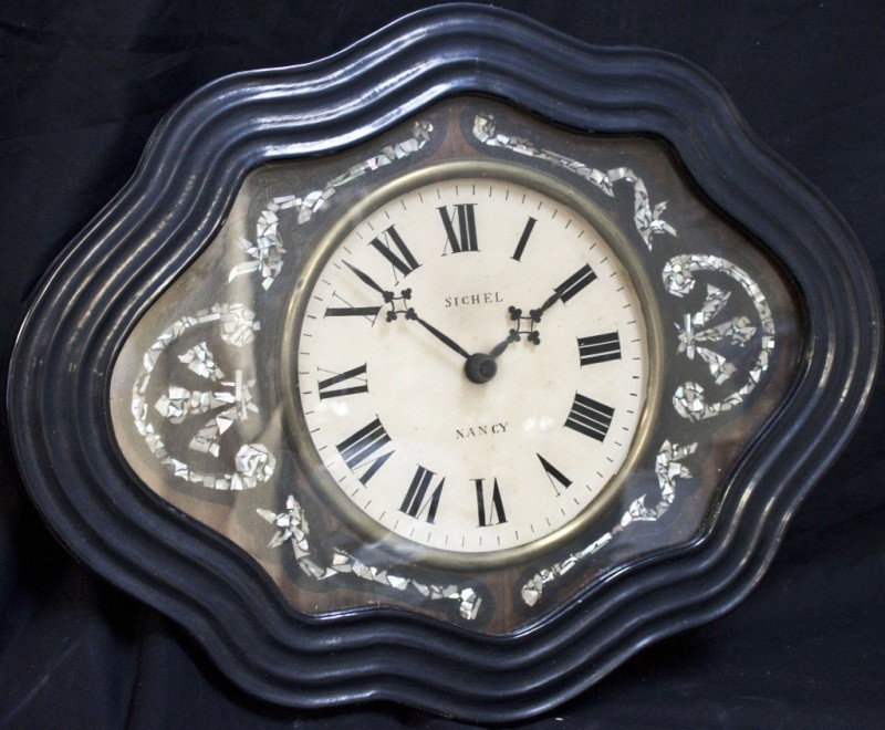 19c French Ebonized W/ Mother Of Pearl Inlay Clock: 19c French Ebonized Wood Clock W/ Mother Of Pearl Inlay In The Form Of Fluer De Lis. Works Not Original 20 x 4 x 15.5