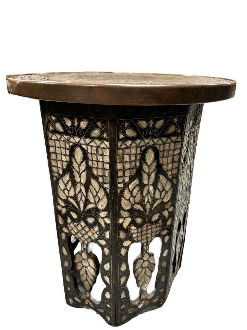 Persian Moroccan Mother of Pearl Carved Table: Antique Persian Moroccan pedestal or tea table with inlayed mother of pearl on carved wood and inscribed brass top. Excellent condition minor loss to mother of pearl. Measures 18" dia. x 20".