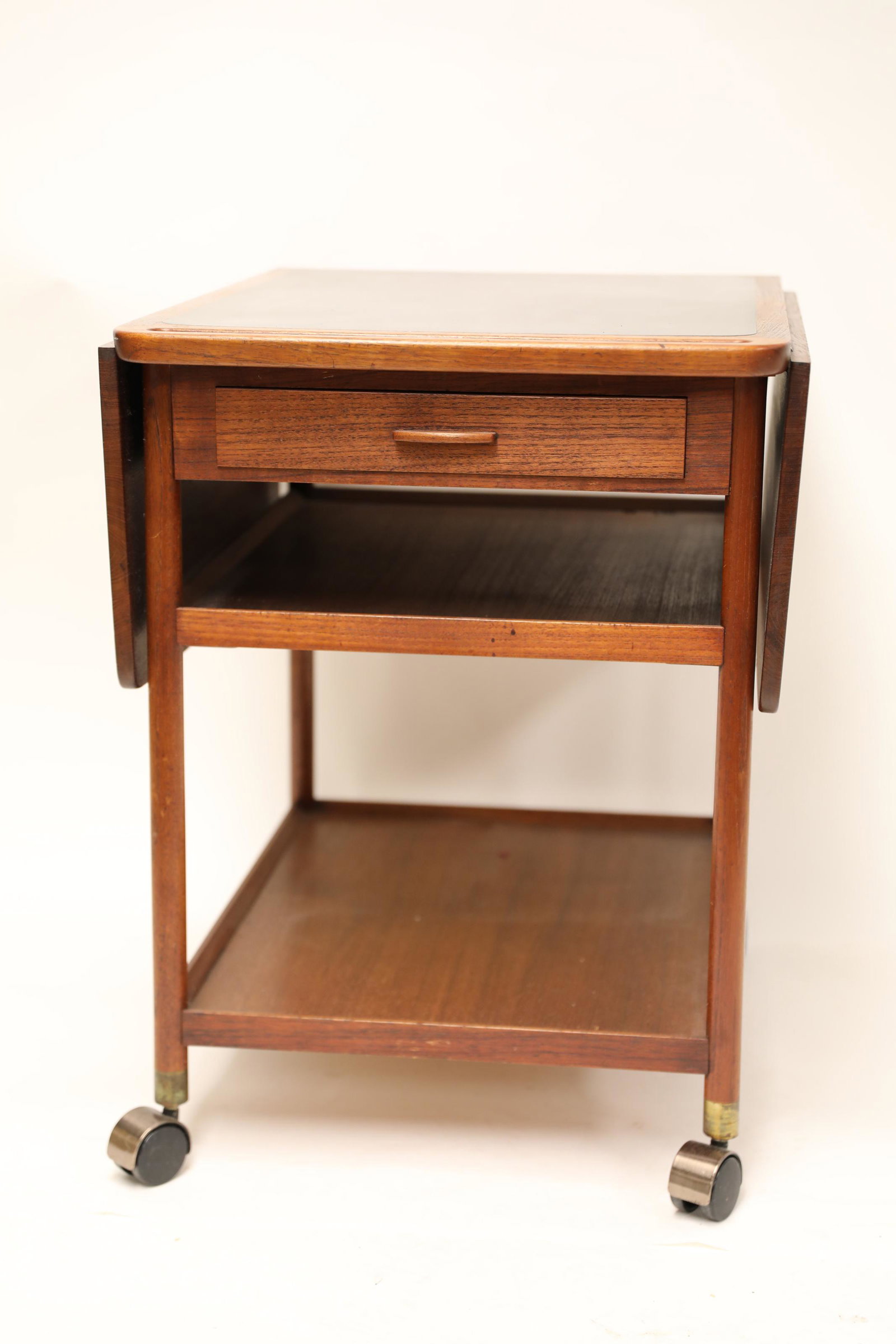Danish Modern Tea Cart w Folding Top: Danish Modern Tea Cart with Mica top and folding top. Features back handle and two lower shelves. Wings adjustable with collapsible sliders. Excellent condition. Measures 27" x 20.5" x 27.5", wings ea