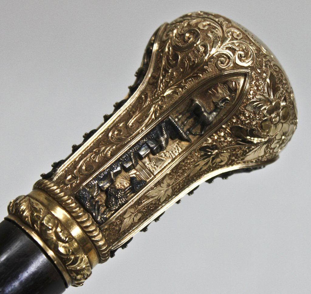 14K Gold Headed 19th Century Judaica Cane: Very finely detailed and heavily chased gold-handled presentation cane with decorative silver mounts depicting mountain goats and intricate crests. Ebony wood shaft with steel tip held by nickel colla
