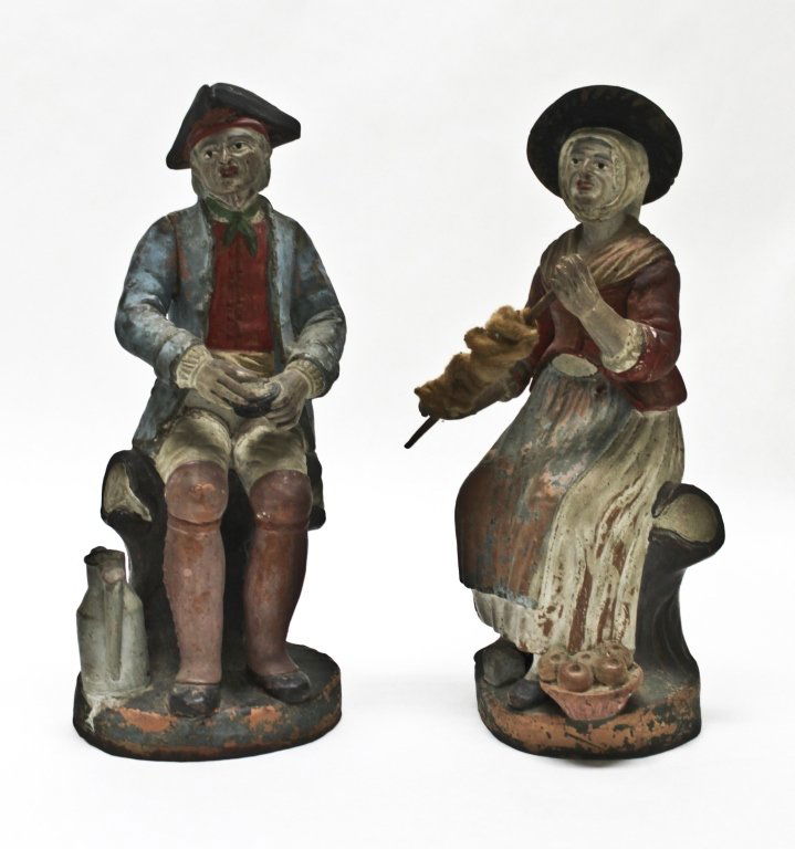 18/19th Century Terracotta Colonial Figurines: Pair (2) of 18th-19th Century colonial terracotta figurines from the Mid-Atlantic Seaboard. Elderly man and woman, hand painted with milk paint. Woman holding spool with actual cotton/wool. Minor hole