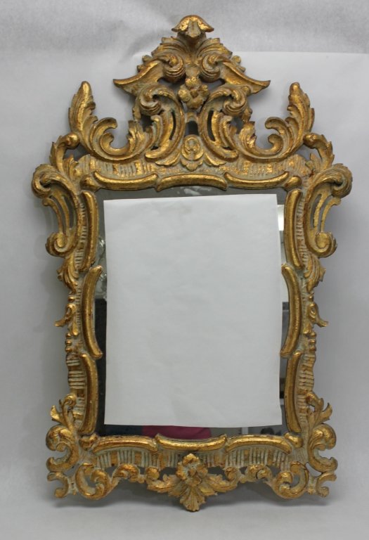 Hand Carved Gilt Wood Rocco Mirror: Hand carved French Rococo style gilt wood mirror. Well carved and gilted wooden mirror Measurements: 27" x 41" x 3" Style: Modern