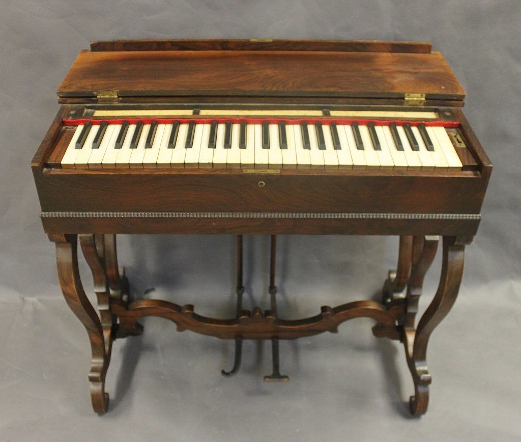 1860 George A. Prince Carved Walnut Melodeon: Beautiful melodeon built by George A. Prince in 1860. These instruments are small reed organs that are operated by pumping the large iron right pedal...the left pedal is volume control and operates a
