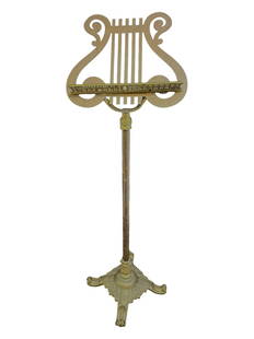 Early 20th Century bronze lyre form music stand lectern or art easel. Ornate bronze shelf attaches: Early 20th Century bronze lyre form music stand lectern or art easel. Ornate bronze shelf attaches to stand. Old, non telescoping stand. The back of the stand has shiny finish. Base has art nouveau de