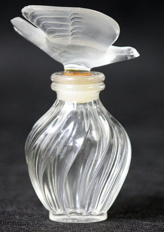 Lalique Crystal Perfume Bottle with Dove Stopper: Lalique crystal perfume bottle with a frosted crystal art glass dove stopper. Excellent condition and signed on the bottom. Measurements: 2 x 2" x 3.5" Artist: Lalique Style: 20thC