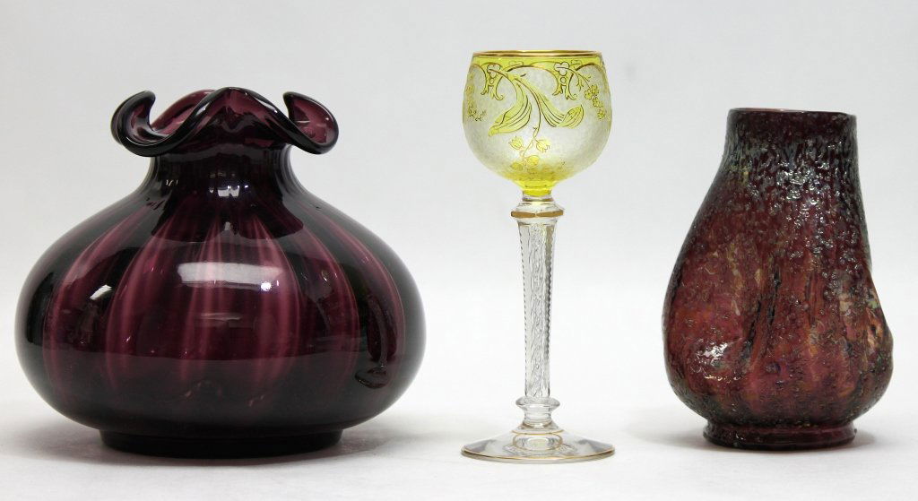 (3) Czech Art Glass, NJ Art Glass: Two pieces of Czechoslovakian art glass. A yellow coated wine glass cut to clear with intricate flower detail and a spiral enclosed in the stem. Measures 3dia x 7.25". Loetz style Dugan purple vase wi