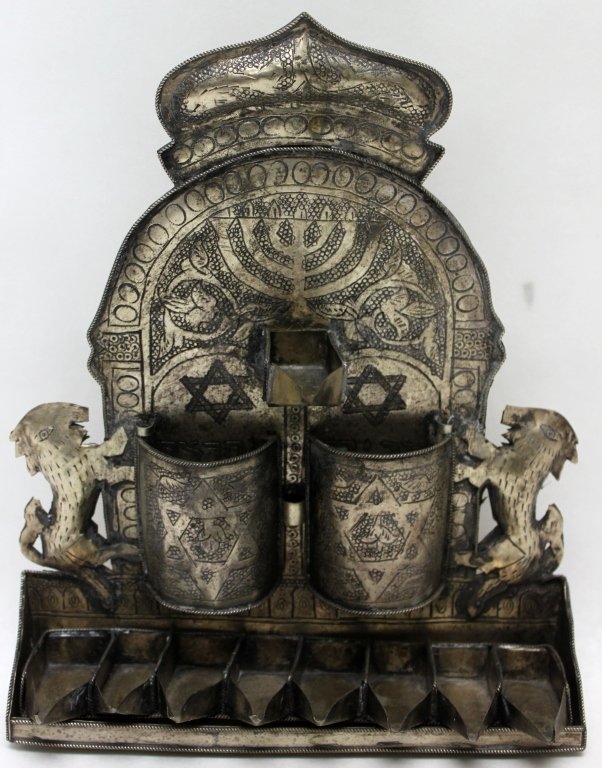 Silver Plate Mid-Century Wall Menorah: Silver plate mid-century oil burning wall menorah with lions and crown. Measurements: 8.75 x 3.5" x 11"" Style: Mid-Century