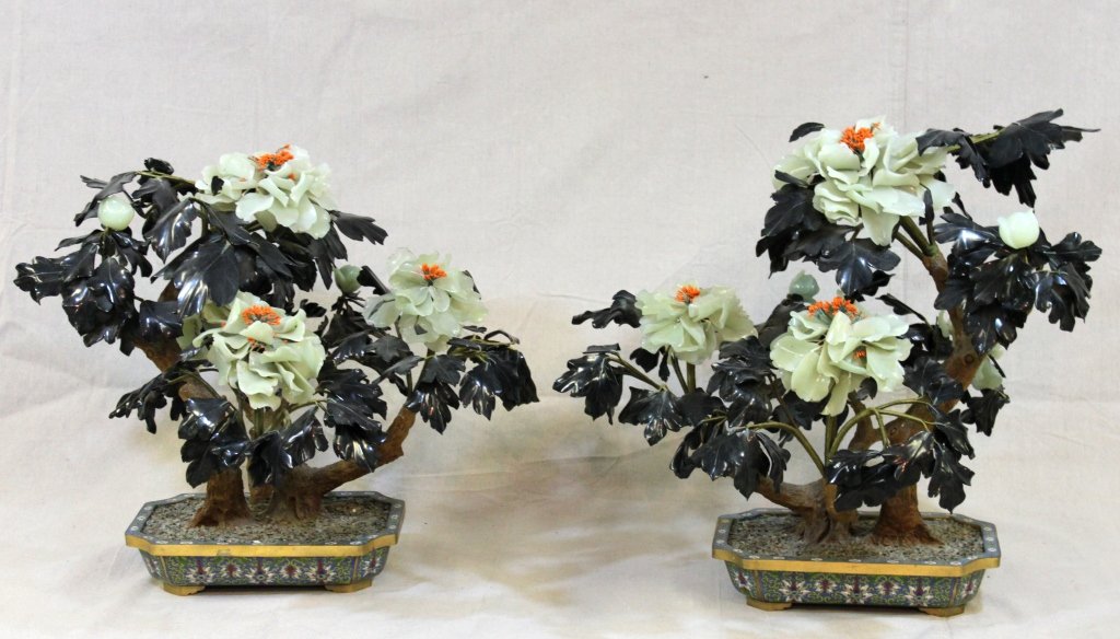(2) Jade Trees in Cloisonne Planters: Pair of black and cream jade trees with lacquered wood trunks. Each measures approximately 24 x 19" x 25" in 14" x 9" x 3.5" cloisonne planters with gold coated wire and bronze." Measurements: See Des