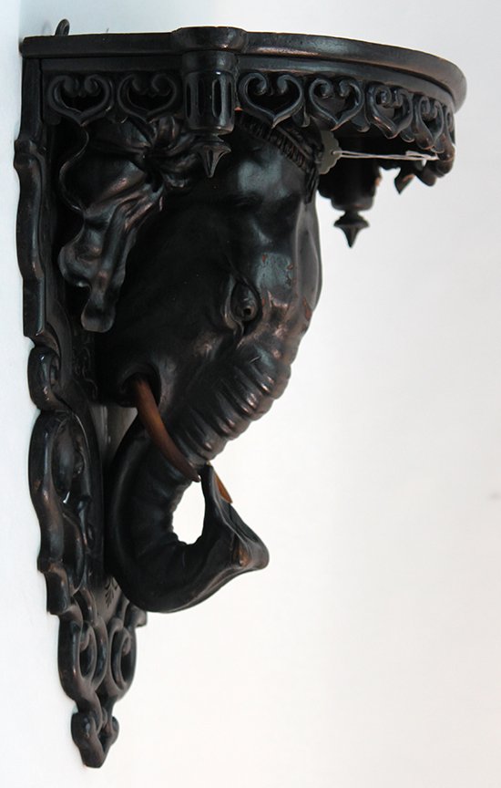 19thC Carved Wooden Elephant Wall Shelf: British Imperial period carved wooden figural wall shelf of an elephants head. Ebonized. Some minor loss to wood, besides that very good condition. Measurements: 14 x 12" x 17"" Style: 19thC