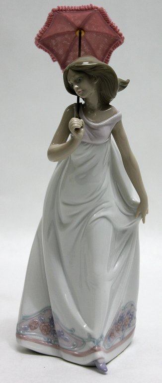 Lladro Porcelain Figurine Afternoon Promenade"": Lladro retired porcelain figurine Afternoon Promenade" of a young woman in a flowing white dress with a pink parasol. Sculpted by José Puche and produced between 1995 and 1998." Measurements: 4.25 x 