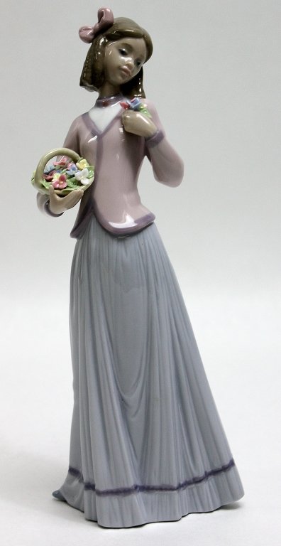 Lladro Porcelain Figurine Innocence in Bloom"": Lladro retired porcelain figurine Innocence in Bloom" sculpted by José Puche and produced between 1996 and 1998." Measurements: 4 x 2.5" x 9.5"" Artist: Lladro, José Puche Style: MidC Modern