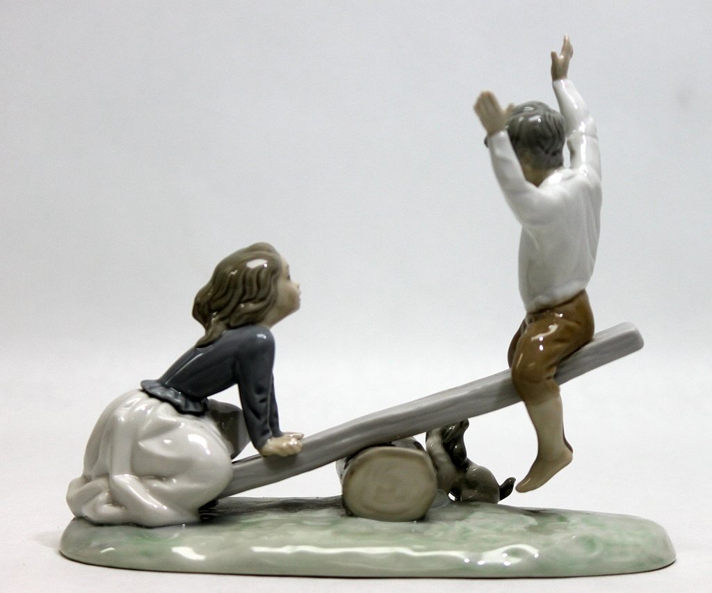 Lladro Porcelain Children on a Teeter Totter: Lladro porcelain figurine of children playing on a teeter totter or see-saw. Measurements: 9.5 x 4.5" x 8"" Artist: Lladro Style: MidC Modern