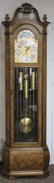 Herschede Nine Tube Grandfather Clock: Herschede nine tube grandfather clock with a burl wood Bombay case and an ornately carved scroll pediment. Three weights and pendulum. Serial Number 637714, model 250 Measurements: 25" x 13" x 87" Art