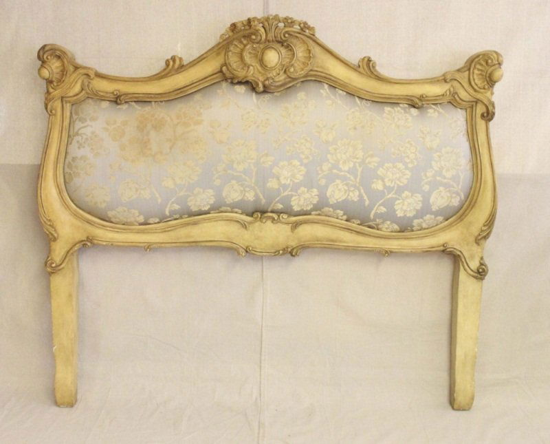 French Rococo Queen Size Headboard: French Rococo style queen size headboard with fine carved detail work and a silk backing. Measurements: 62" x 4.5" x 55" Style: Early 20th Century